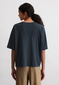Dark blue short-sleeve t-shirt with a relaxed fit and crew neckline, made from soft fabric. The back features a smooth texture and subtle sheen.