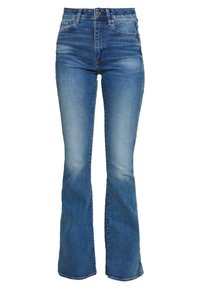 Jeans acampanados de mezclilla azul con cintura alta, que presentan áreas desgastadas y el clásico estilo de cinco bolsillos. Textura suave con costuras visibles.