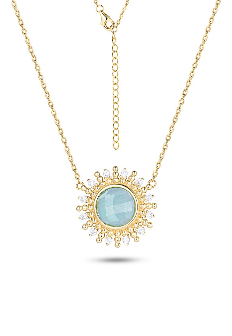 Collier en chaîne dorée avec un pendentif en pierre précieuse bleue ronde entouré de perles dorées et de petits cristaux transparents.