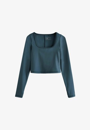 Teal long-sleeve crop top made from smooth, stretchy fabric. Features a square neckline and a subtle logo accent on the side.