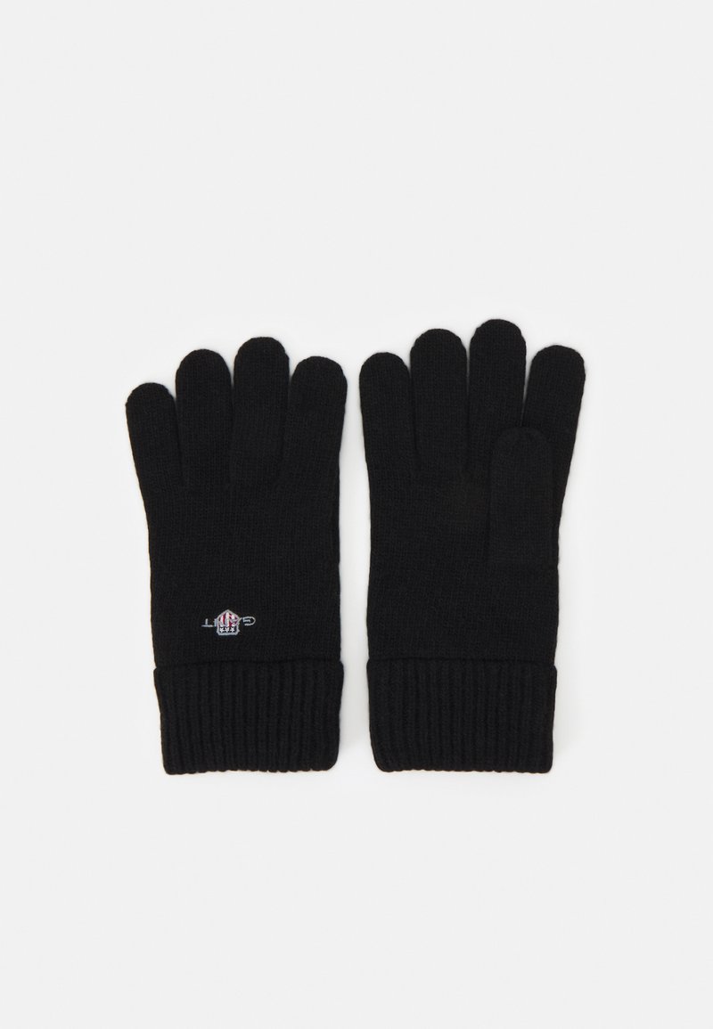 Black knitted gloves with a ribbed cuff. Features a small logo on the wrist area. Made from soft, warm fabric with individual finger slots.