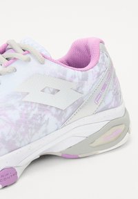 Purple and white athletic shoe featuring a textured finish, mesh upper, padded collar, and prominent logo on the side. Accents in pink.