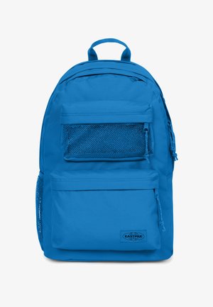 Niebieski plecak z tkaniny z uchwytem u góry, przednią siateczkową kieszenią i dwiema bocznymi kieszeniami. Posiada zamki błyskawiczne i metkę z logo na dolnej części przodu.