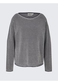 Pull à manches longues noir et blanc à motif, avec col rond et coupe légèrement ample sur fond neutre.