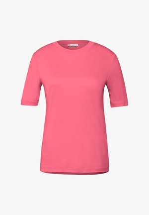 Rosa kortärmad t-shirt i mjuk bomull; har rund hals och rak fåll med minimal sömnad. Varumärkesetikett synlig inuti halsringningen.