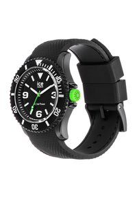 Black solar-powered watch with a textured black silicone band, green crown, and white hour markers featuring a divers' bezel and clear face.