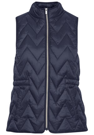 Tamsiai mėlyna be rankovių pūkinė liemenė su zigzaginiu siuvinėjimu, aukštu apykakle ir užtrauktuku priekyje. Yra surinkta liemens linija, kuri suteikia formą.