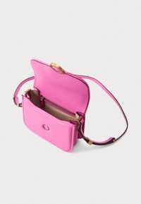 Borsa a tracolla in pelle rosa con una texture liscia, forma arrotondata e accessori in metallo dorato. Contiene una tasca interna beige e una tracolla regolabile.