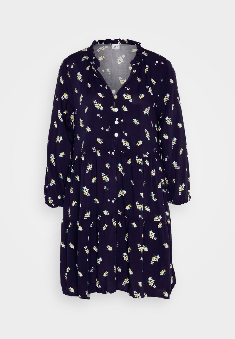 Robe bleu marine à fleurs avec manches longues, col à volants, boutonnée sur le devant et jupe à volants, ornée de petites fleurs blanches et jaunes.