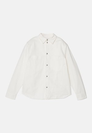 White button-up shirt, long sleeves, two chest pockets, and a point collar. Made of a soft, textured fabric with metallic buttons.