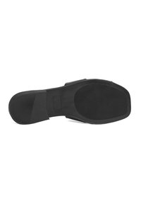Semelle de chaussure noire en caoutchouc texturé, de forme plate et aux bords lisses. Présente un panneau rectangulaire au centre et divers motifs de semelle.