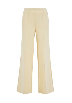Pantalon à jambes larges de couleur crème avec taille élastique et détails de coutures verticales, conçu pour une coupe décontractée.