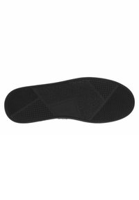 Suola in gomma nera con modelli di grip testurizzati, inclusi design esagonali, floreali e a puntini per una maggiore trazione.
