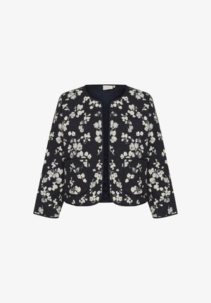 Veste matelassée bleu marine foncé avec motif floral blanc, col rond, deux poches avant et manches longues. Le tissu texturé accentue le design.