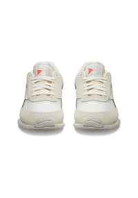 White and beige sneakers with leather and suede materials, featuring a lace-up design, textured accents, and a rubber sole. Reebok branding visible.