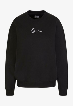 Schwarzer Sweatshirt mit rundem Ausschnitt und gerippten Bündchen. Mit einem weißen gestickten Design auf der Brust. Aus weichem Material gefertigt.
