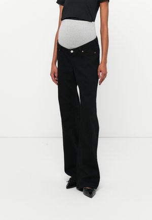 Schwarze ausgestellte Jeans mit einem grauen elastischen Umstandsband. Mit Knopfverschluss, seitlichen Taschen und einem glatten Stoffgefühl.