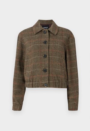 Brun houndstooth cropped jakke med krage, seks svarte knapper, og kontrasterende røde og beige linjer gjennom den vevde teksturen.