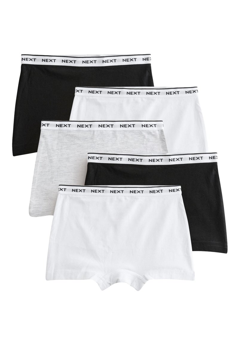 Five pairs of shorts in black, grey, and white, made from soft fabric. Each features a black elastic waistband with "NEXT" printed.
