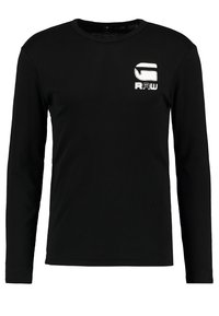 Zwarte longsleeve crewneck shirt met witte "G RAW" logo op de linkerborst. Eenvoudig, effen kleur zonder extra ontwerp.