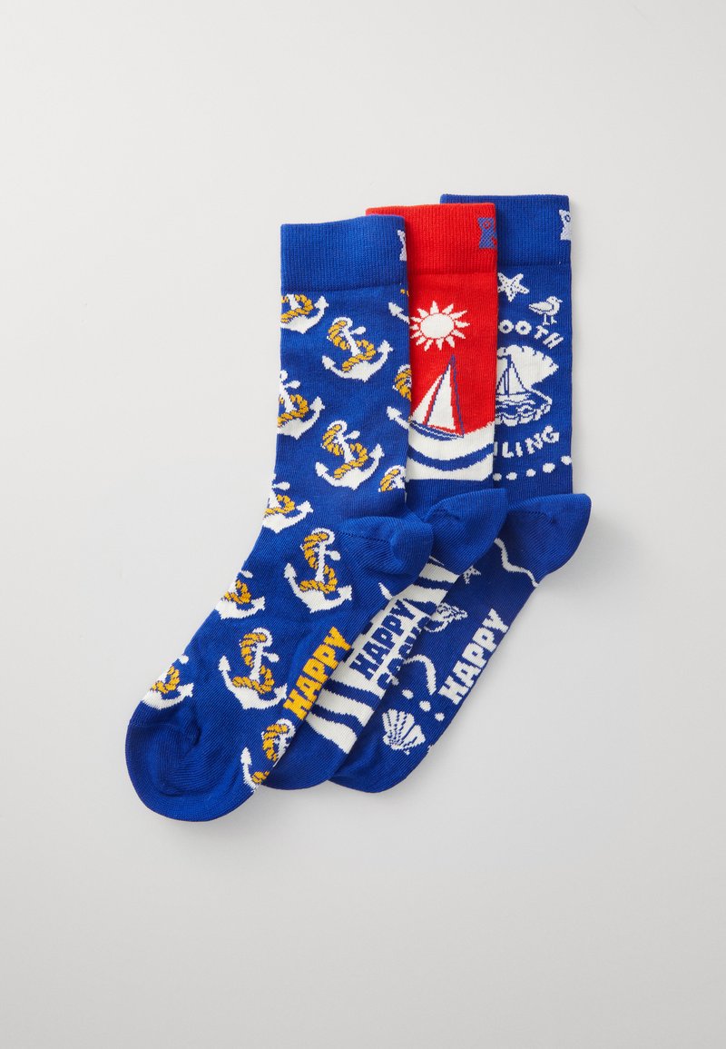 Three pairs of blue socks featuring nautical designs: anchors, sailing boats, and seashells, with red accents and text reading "HAPPY."
