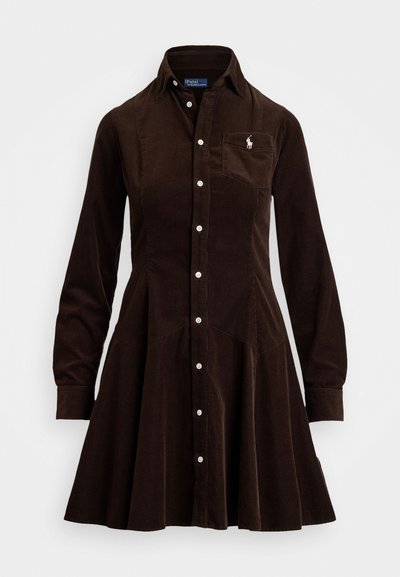 Brown corduroy shirt dress with long sleeves, button-down front, fitted bodice, flared skirt, and a small embroidered logo on the chest pocket.