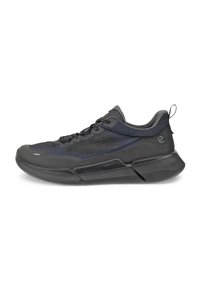 Black athletic shoe featuring a textured fabric upper, mesh panels, and a sturdy rubber sole. Design includes a pull tab at the rear.