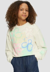 Crème-kleurige sweatshirt met lange mouwen, versierd met grote, meerkleurige bloemenontwerpen in pastelkleuren. Gemaakt van een zachte katoenstructuur.