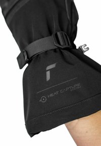 Black waterproof glove cuff with adjustable strap. Features embossed logo and text "HEAT CAPTURE SYSTEM." Smooth fabric texture.