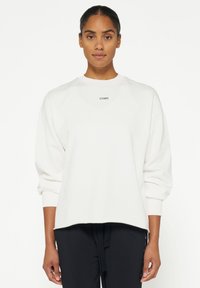 Witte sweatshirt met ronde hals, lange mouwen en een ontspannen pasvorm. Beschikt over een klein zwart logo "10 DAYS" op de borst.