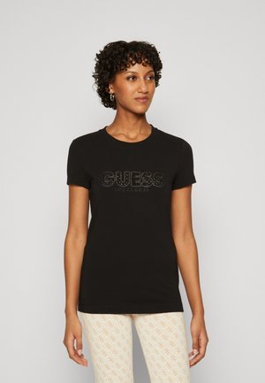 T-shirt in cotone nero con logo "GUESS LOS ANGELES" tempestato di strass sul davanti. Maniche corte e scollatura a giroclassico.
