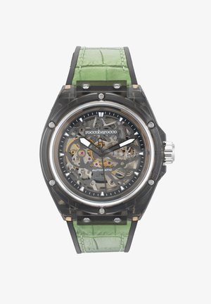 Skeleton pulksteņi ar caurspīdīgu korpusu, melnu ciparnīcu, sudraba rokturiem un zaļu krokodilu-izsistā ādas siksnu. Sudraba apdare.