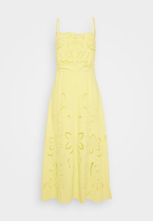 Κίτρινο βαμβακερό φόρεμα με λεπτές τιράντες. Διαθέτει κεντημένα λουλουδάτα σχέδια και κοψίματα σε όλη την φούστα και το σώμα.