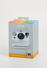 Polaroid Now+ instant camera packaging, featuring a white box with a rainbow stripe, lens, and red button, includes 8 instant photos.