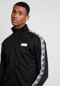 New Balance ATHLETICS CLASSIC TRACK JACKET - Trainingsvest - black