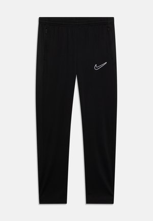 Pantalones deportivos negros hechos de una tela suave, con una cintura elástica, bolsillos laterales y un logo de Nike blanco en el muslo izquierdo.