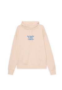 Sudadera beige con capucha y bolsillo frontal, con texto azul que dice "Los Angeles Heritage Collective" en el pecho.