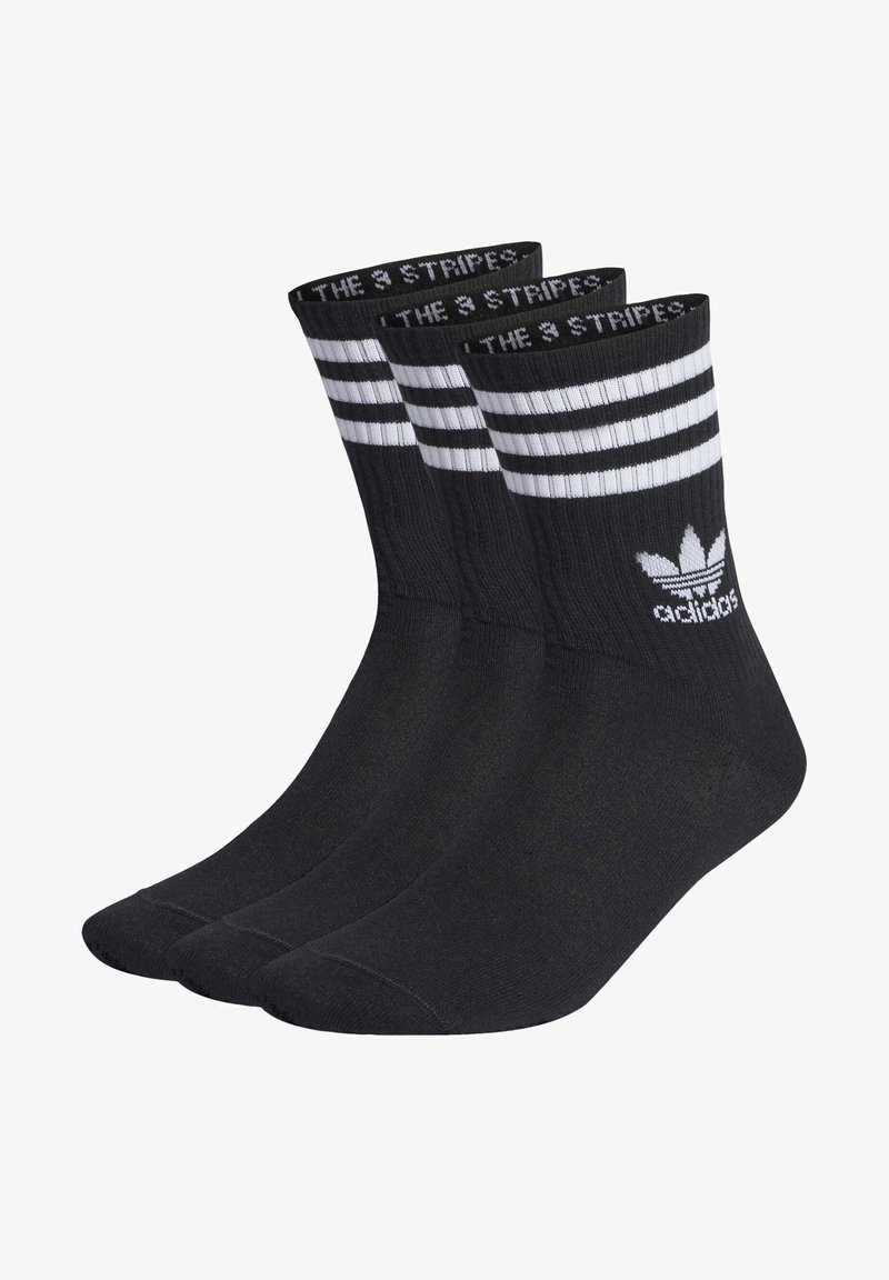 Čierne športové ponožky s tromi bielymi vodorovnými prúžkami na vrchu. Vlastnosti zahŕňajú rebrový textil a logo adidas v bielej farbe.