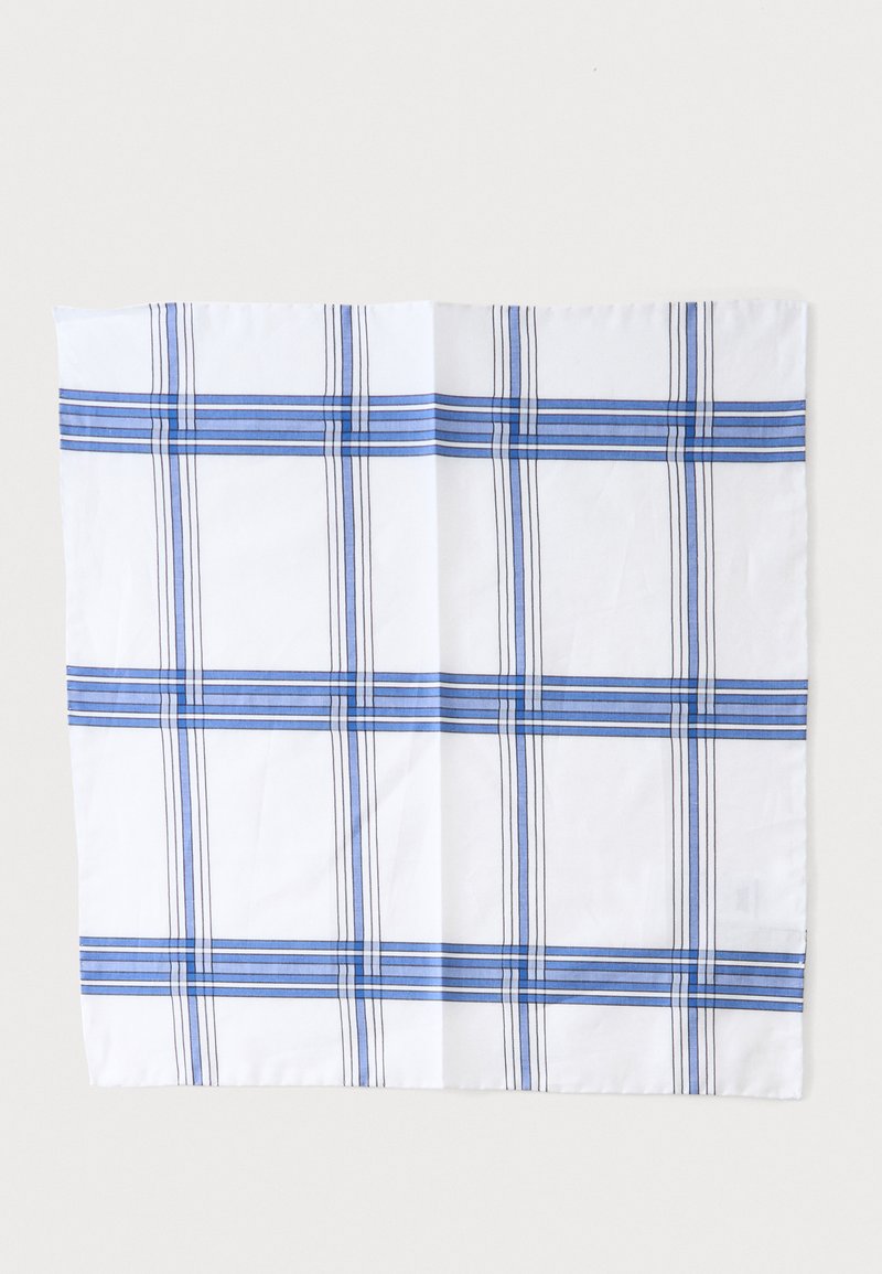 Mouchoir blanc avec un motif à carreaux bleu et noir, plié à plat sur un fond clair.
