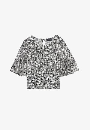 Bluză cu model alb-negru, cu mâneci scurte și evazate,spate cu decolteu în formă de cheie și țesătură ușoară, potrivită pentru a fi purtată la straturi.