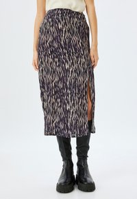 Jupe midi violette à motifs avec une fente sur le côté, en tissu texturé, design abstrait dans des tons crème et beige clair, et un waistband plat.