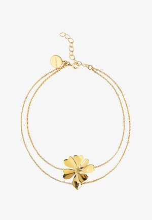 Collier double chaîne en or délicat avec pendentif fleur polie à six pétales et fermoir réglable avec petite étiquette ronde.