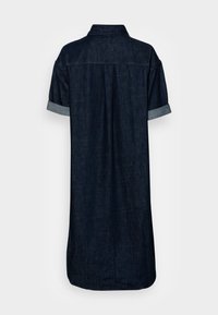 Dark denim shirt dress with a collared neckline, short rolled sleeves, and a straight cut. Features a back pleat and a longer rear hem.