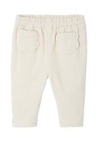 Cremefarbene gerippte Babypants mit elastischem Bund und gewellten aufgesetzten Taschen auf der Rückseite.