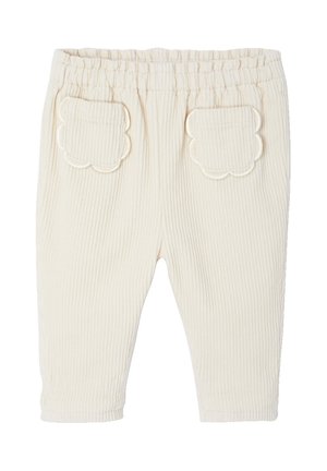 Cremefarbene gerippte Babypants mit elastischem Bund und gewellten aufgesetzten Taschen auf der Rückseite.