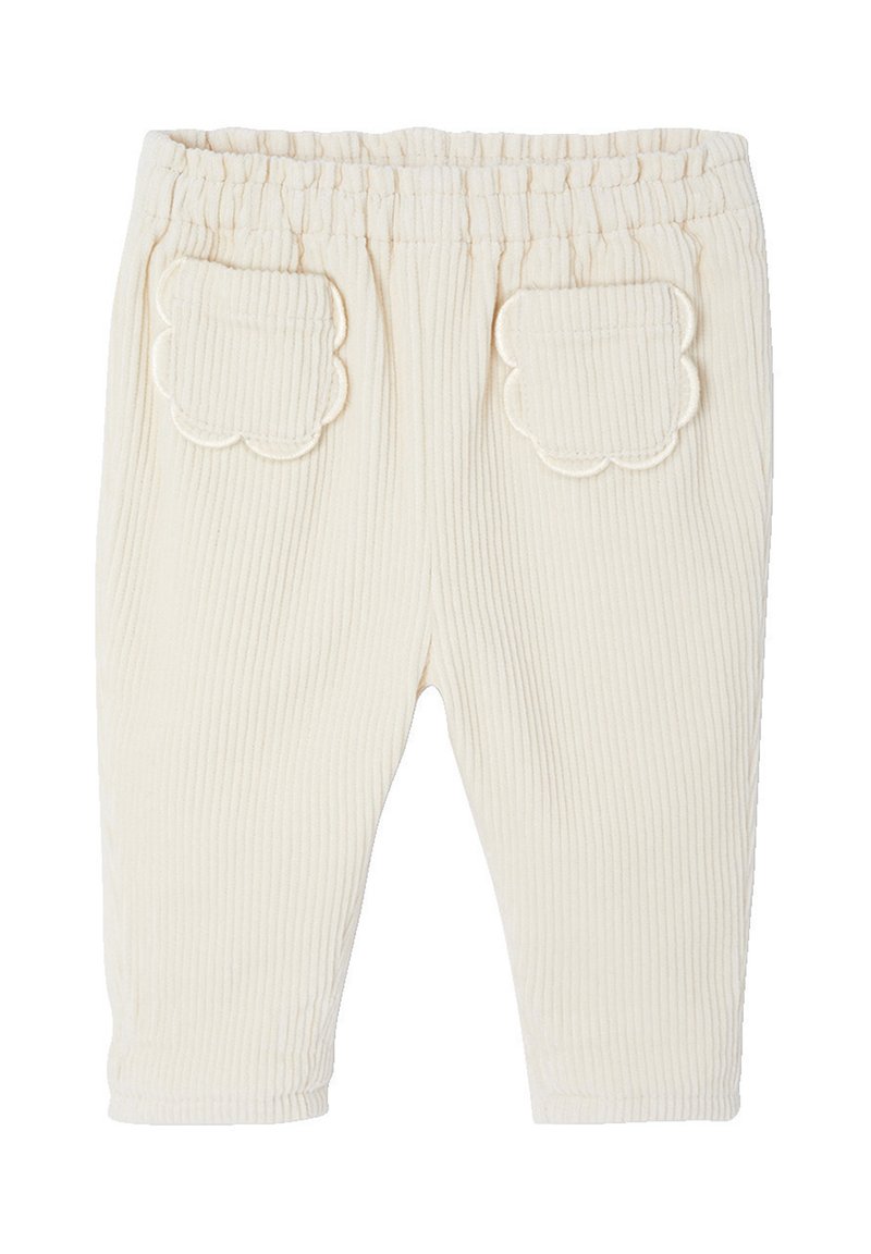 Cremefarbene gerippte Babypants mit elastischem Bund und gewellten aufgesetzten Taschen auf der Rückseite.