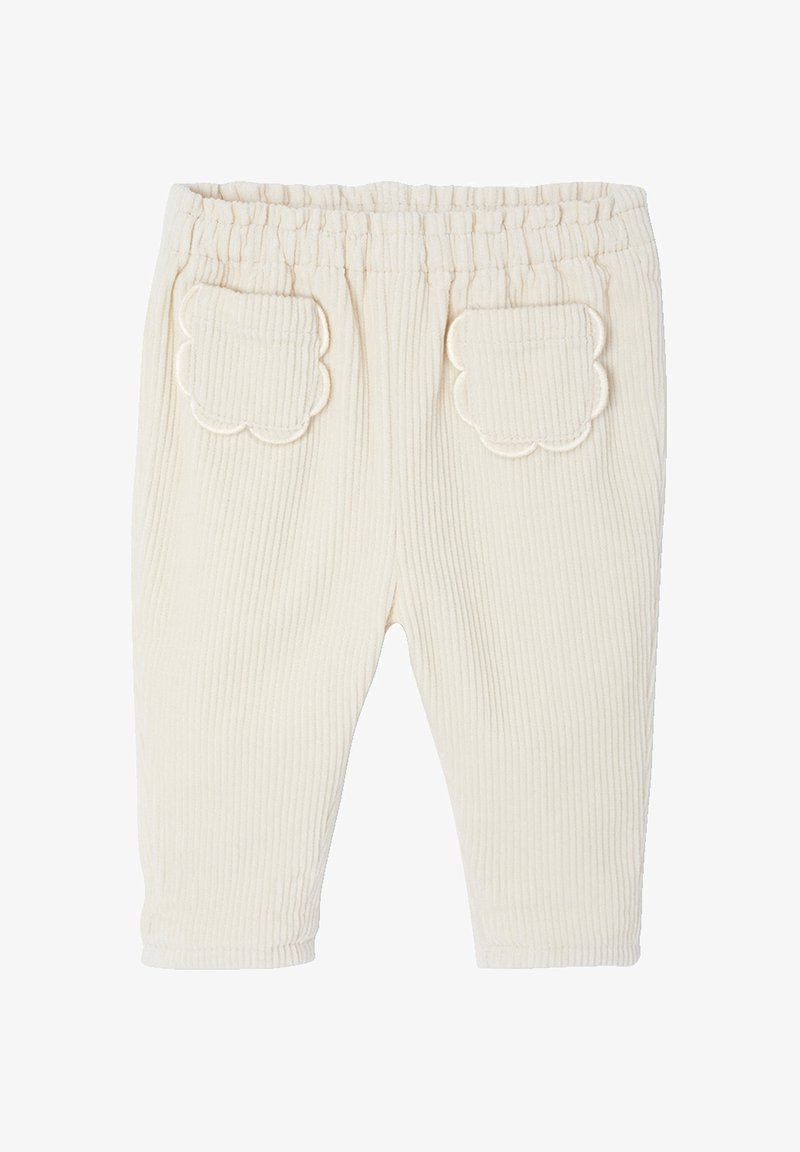 Cream ribbed baby pants with elastic waistband and scalloped patch pockets on the back.