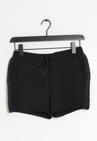 Pantaloni pantaloni neri realizzati in un tessuto morbido, caratterizzati da una vita con cordoncino e dettagli decorativi intrecciati sui lati. Texture liscia, design informale.