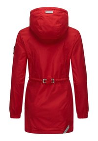 Red waterproof jacket with a cinched waist, hood, and long sleeves. Features metal accents and a logo label on the back. Smooth texture.