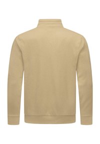 Felpa crema con zip realizzata in tessuto strutturato; presenta un colletto alto e polsini e orlo a costine. Design semplice e neutro.